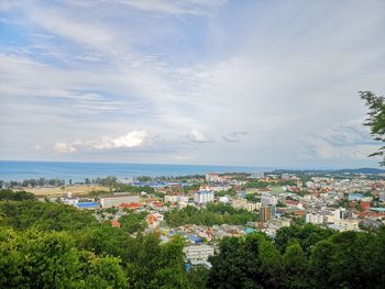 High angle view of townscape by sea against sky