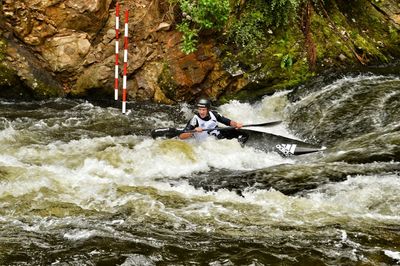 Full length of woman jumping in water