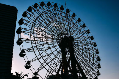 Low angle view of ferris wheel against clear sky