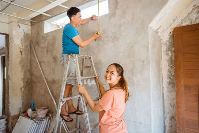 Side view of young woman working in workshop