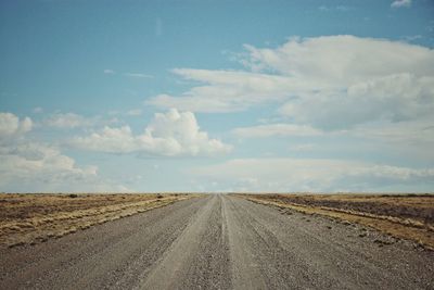 Empty road along countryside landscape