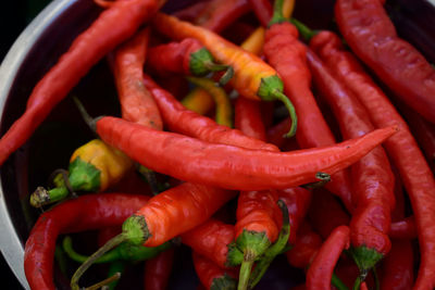 Close-up of red chili peppers in container