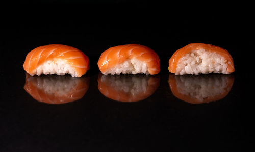 Close-up of sushi against black background