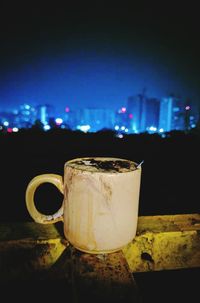 Close-up of coffee cup at night