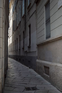 Empty alley amidst buildings in city