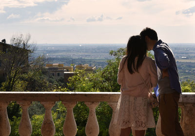 Couple standing against sky in balcony