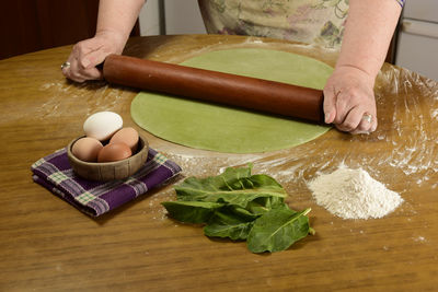 High angle view of woman holding food on table