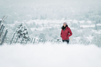 Woman standing on snow covered field