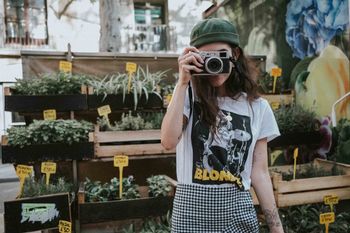 WOMAN PHOTOGRAPHING WITH UMBRELLA