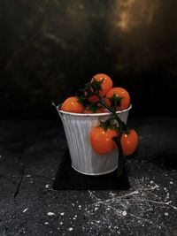 Close-up of orange fruits in bowl on table