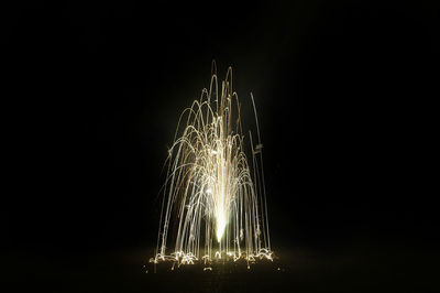 Close-up of illuminated lighting equipment against black background