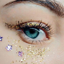 Close-up of girl eye with decoration and glitters