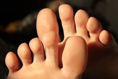 Close-up of human hand against black background