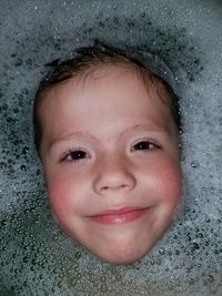 Portrait of smiling boy in water