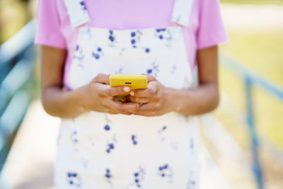 Midsection of woman using mobile phone