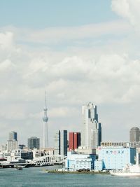 Modern buildings by city against sky