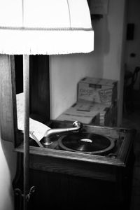 Close-up of electric lamp on table at home