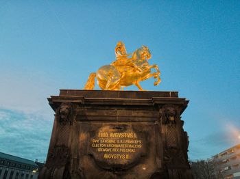 Low angle view of statue against blue sky