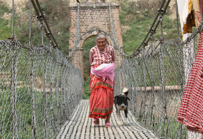 Full length of girl standing against wall