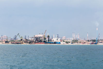 Commercial dock by sea against sky