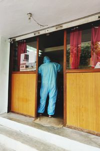 Rear view of man standing outside building