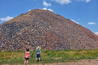 Children looking at pile of pebbles