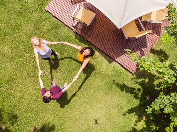 Aerial view of the family with a drone. the family playing roundelay in their backyard.