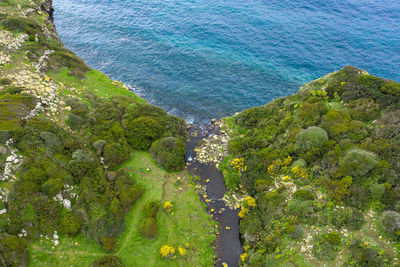 High angle view of rocks by sea