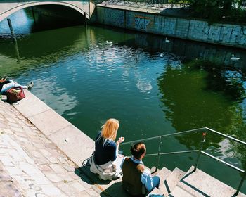 Man sitting on bench in lake