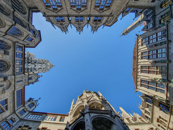 Low angle view of buildings against blue sky