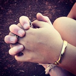 Low section of couple holding hands