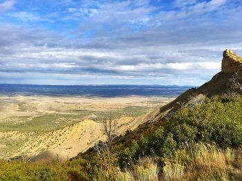 Scenic view of landscape against cloudy sky