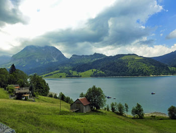 Scenic view of lake and mountains against sky