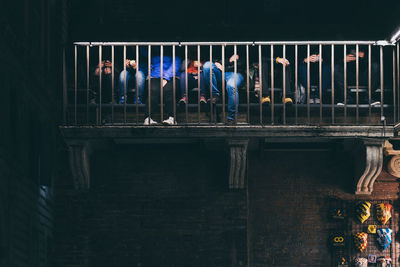 People standing by railing at night