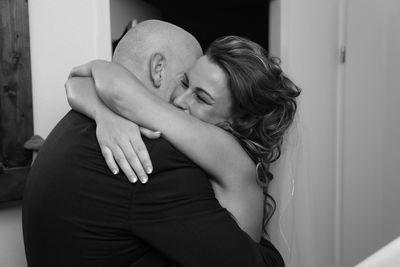 Couple embracing at home