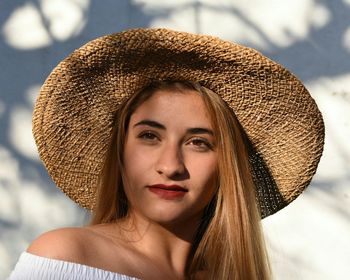 Portrait of beautiful young woman against sky