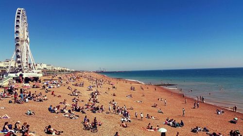 Scenic view of beach against blue sky