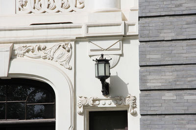 Low angle view of electric lamp on building