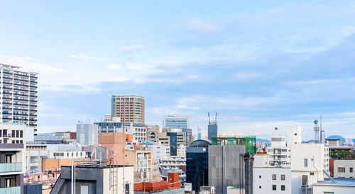 Buildings in city against sky