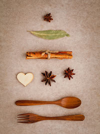 Close-up of spices with wooden spoon and fork