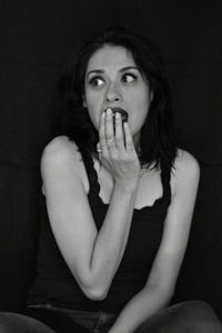 Shocked woman over black background