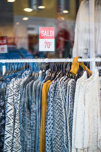 Clothes hanging on rack in store for sale