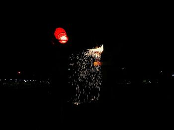 Illuminated firework display at night