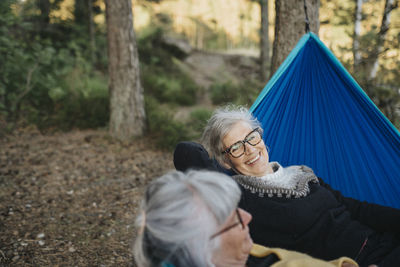 Two senior women resting in hammock