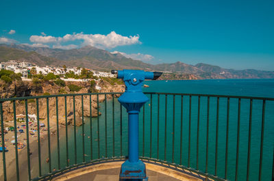 View from a tourist observation telescope with the beautiful beach of nerja in the background.