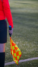 Rear view of woman holding umbrella