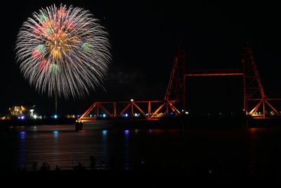 Firework display over bridge at night