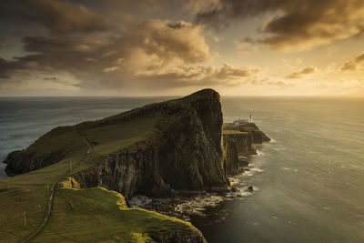 Scenic view of sea against cloudy sky during sunset