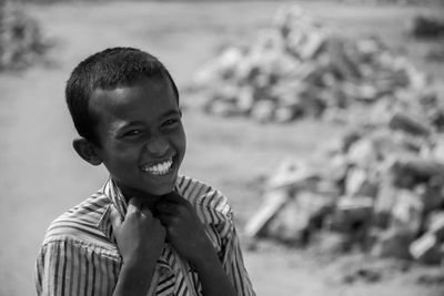 Portrait of smiling boy standing outdoors