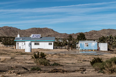 Small church in joshua tree, california by mountain against sky